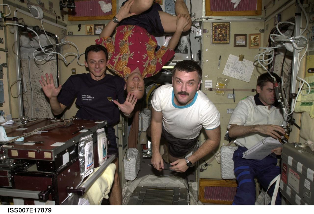 ISS007-E-17879 (October 2003) --- European Space Agency (ESA) astronaut Pedro Duque (left) of Spain; astronaut Edward T. Lu, Expedition 7 NASA ISS science officer and flight engineer; cosmonaut Alexander Y. Kaleri, Expedition 8 flight engineer; and cosmonaut Yuri I. Malenchenko, Expedition 7 mission commander, are pictured in the Zvezda Service Module on the International Space Station (ISS). Kaleri and Malenchenko represent Rosaviakosmos. Though the exact date is unavailable, the scene was recorded about midway through the joint duty time of Expeditions 7 and 8.