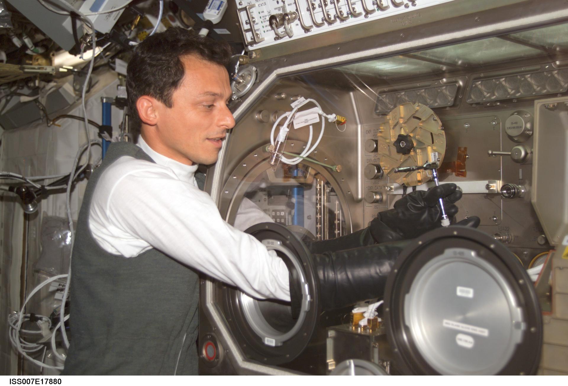 Retired European Space Agency (ESA) astronaut Pedro Duque works on an early iteration of the PromISS investigation series in the Microgravity Science Glovebox (MSG)