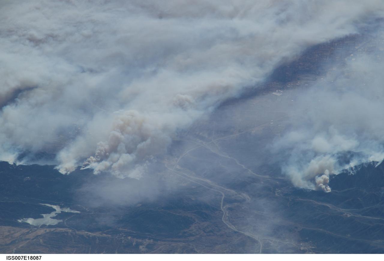 ISS007-E-18087 (26 October 2003) --- The fires in the San Bernardino Mountains, fueled by Santa Ana winds, burned out of control on the morning of Oct. 26, 2003, when this image and several others were taken from the International Space Station. This frame and image numbers 18086 and 18088 were taken at approximately 19:54 GMT, October 26, 2003 with a digital still camera equipped with a 400mm lens. Silverwood Lake is visible at the bottom of the image. Content was provided by JSC&#0146;s Earth Observation Lab. The International Space Station Program {link to http://spaceflight.nasa.gov} supports the laboratory to help astronauts take pictures of Earth that will be of the greatest value to scientists and the public, and to make those images freely available on the Internet. Additional images taken by astronauts and cosmonauts can be viewed at the NASA/JSC Gateway to Astronaut Photography of Earth [link to http://eol.jsc.nasa.gov/].