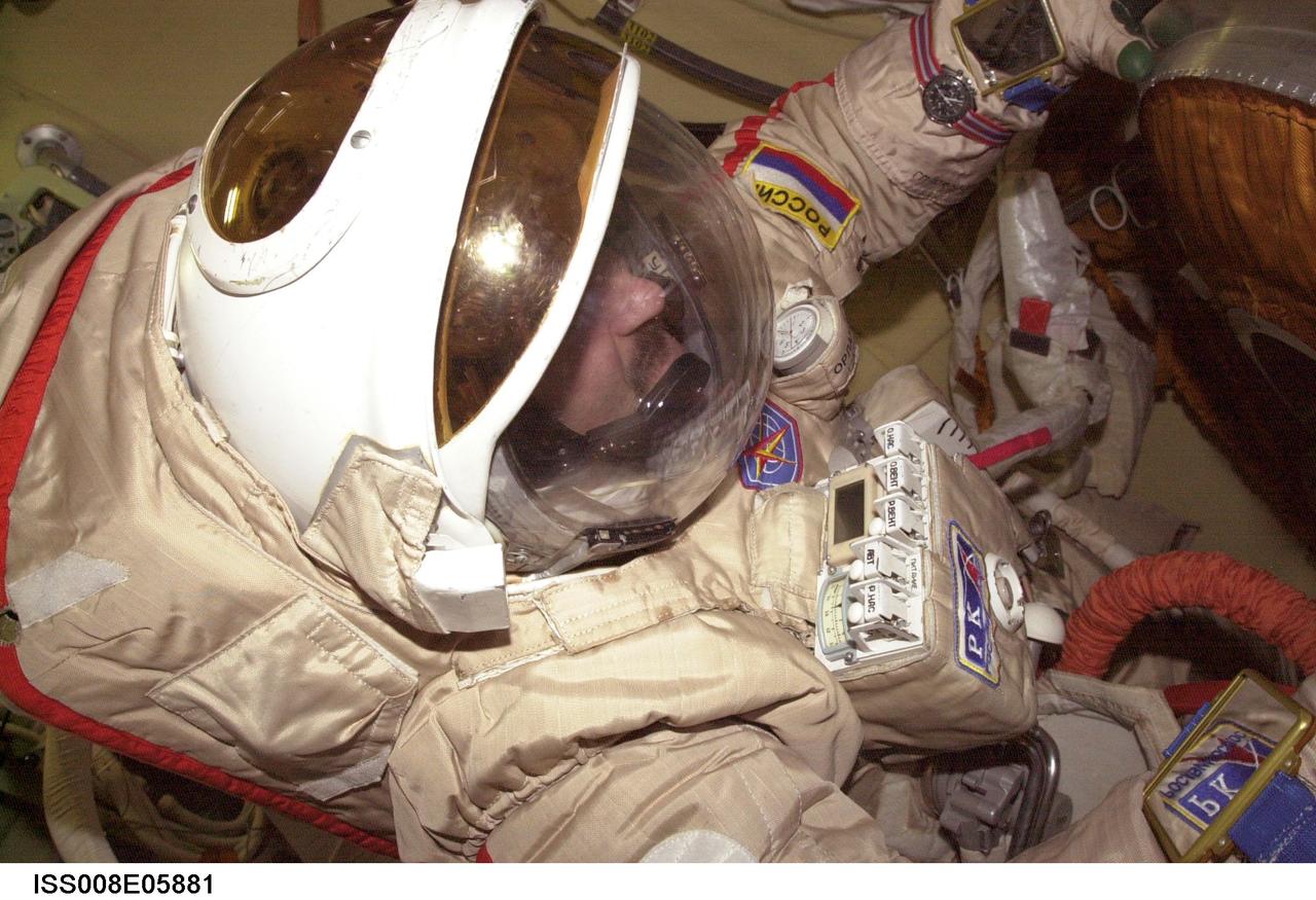 ISS008-E-05881 (November 2003) --- Cosmonaut Alexander Y. Kaleri, Expedition 8 flight engineer, attired in his Russian Orlan spacesuit, is pictured in the Pirs Docking Compartment on the International Space Station (ISS). Kaleri represents Rosaviakosmos.