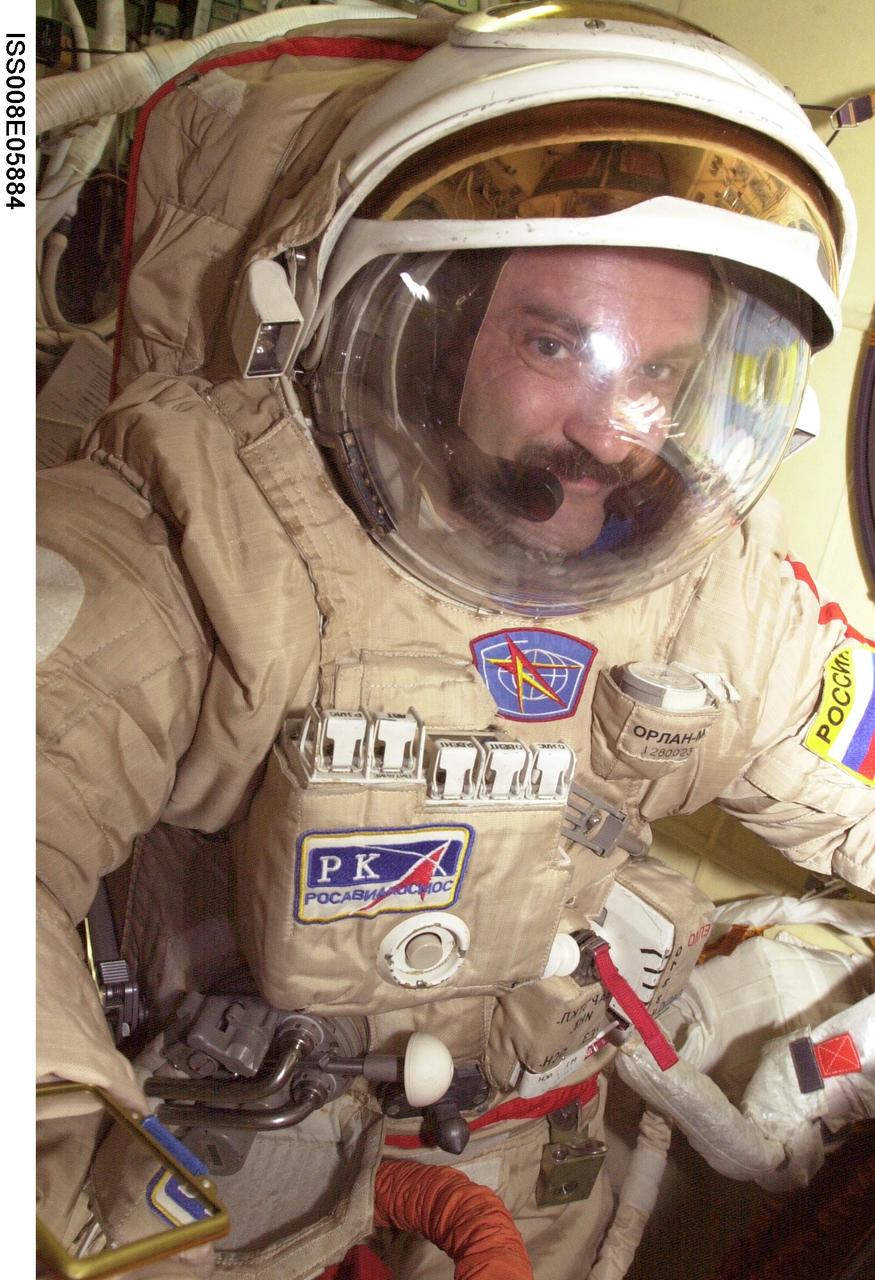 ISS008-E-05884 (November 2003) --- Cosmonaut Alexander Y. Kaleri, Expedition 8 flight engineer, attired in his Russian Orlan spacesuit, is pictured in the Pirs Docking Compartment on the International Space Station (ISS). Kaleri represents Rosaviakosmos.