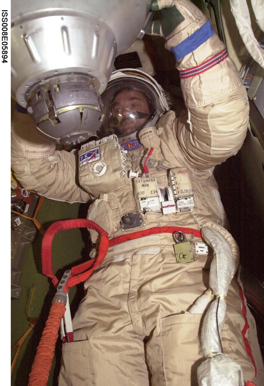 ISS008-E-05894 (November 2003) --- Cosmonaut Alexander Y. Kaleri, Expedition 8 flight engineer, attired in his Russian Orlan spacesuit, is pictured in a Soyuz spacecraft docked to the Pirs Docking Compartment on the International Space Station (ISS). Kaleri represents Rosaviakosmos.