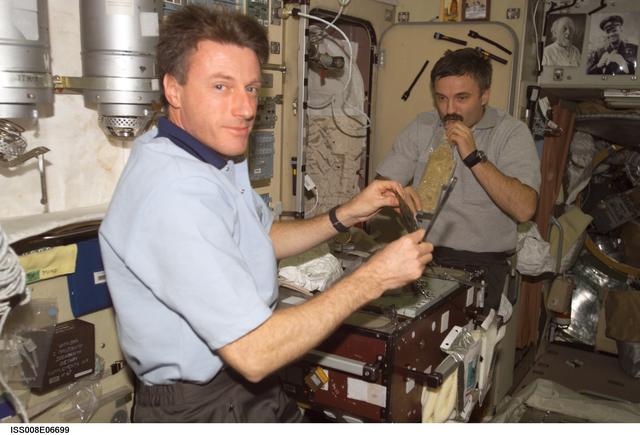 NASA image: Foale and Kaleri during a meal in the galley area of the SM during Expedition 8