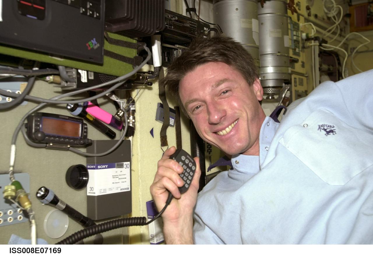ISS008-E-07169 (December 2003) --- Astronaut C. Michael Foale, Expedition 8 mission commander and NASA ISS science officer, uses a communication system in the Zvezda Service Module on the International Space Station (ISS).
