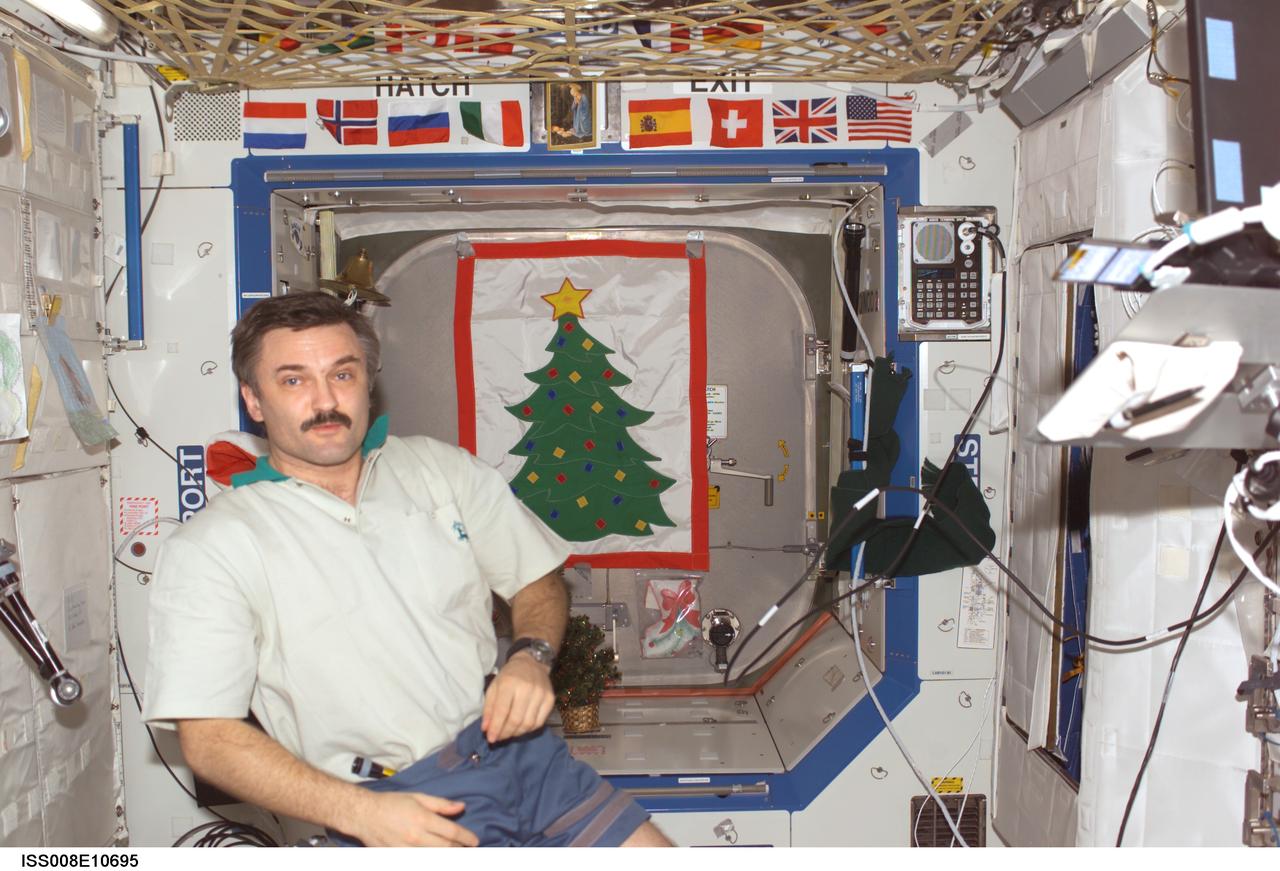 ISS008-E-10695 (28 December 2003) --- Cosmonaut Alexander Y. Kaleri, Expedition 8 flight engineer representing Rosaviakosmos, is pictured in the Destiny laboratory on the International Space Station (ISS). Holiday decorations are visible in the background.