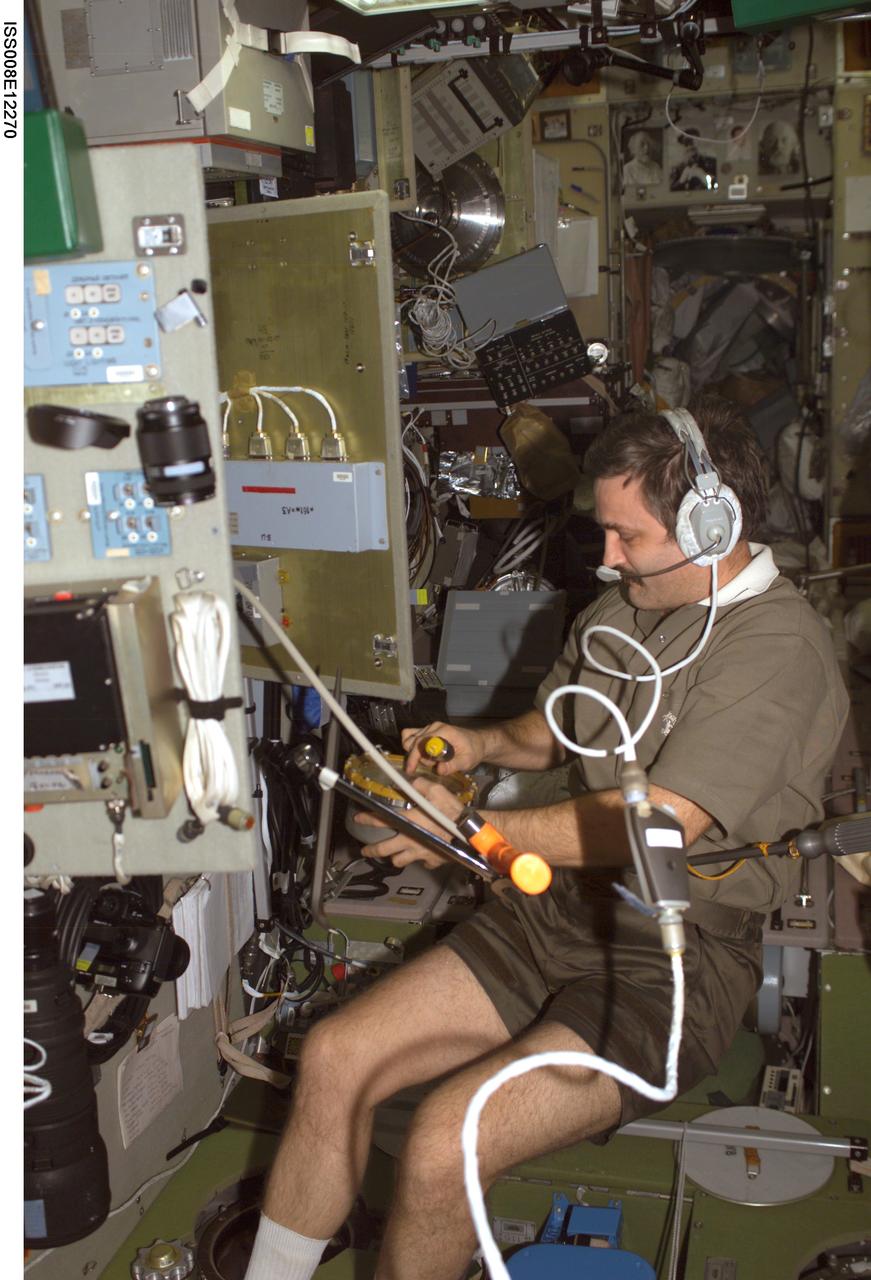 ISS008-E-12270 (9 January 2004) --- Cosmonaut Alexander Y. Kaleri, Expedition 8 flight engineer, uses a communication system as he works in the Zvezda Service Module on the International Space Station (ISS). Kaleri represents Rosaviakosmos.
