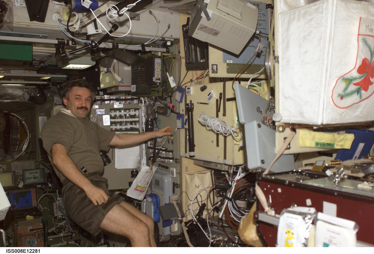 ISS008-E-12281 (9 January 2004) --- Cosmonaut Alexander Y. Kaleri, Expedition 8 flight engineer, works at the Vozdukh CO2 scrubber in the Zvezda Service Module on the International Space Station (ISS). Kaleri represents Rosaviakosmos.