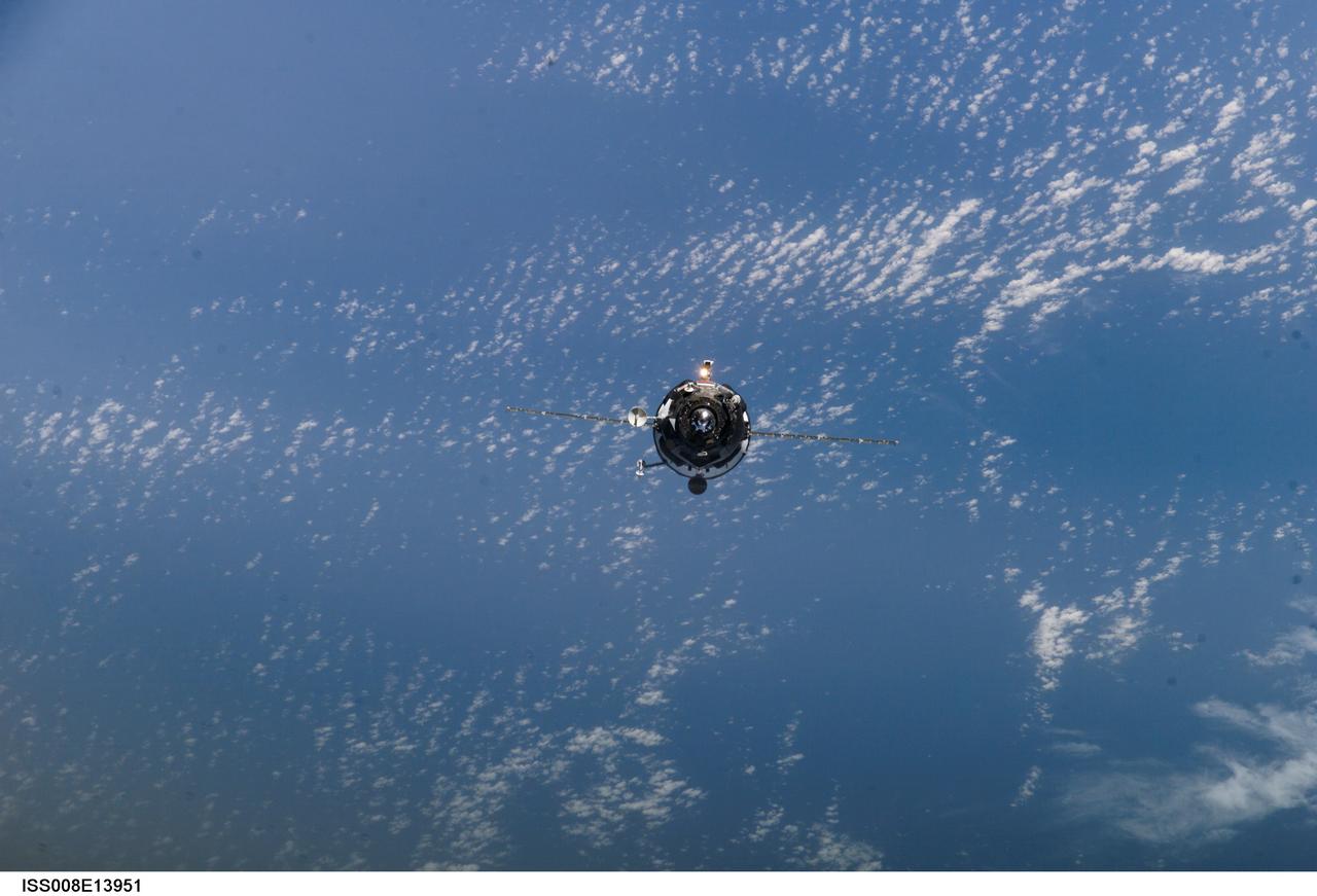 ISS008-E-13951 (31 January 2004) --- Backdropped by a blue and white Earth, an unpiloted Progress supply vehicle approaches the International Space Station (ISS). The Progress 13 resupply craft launched at 5:58 a.m. (CST) on January 29, 2004 from the Baikonur Cosmodrome in Kazakhstan to deliver 2 &#0189; tons of food, fuel, spare parts and supplies to the Expedition 8 crewmembers onboard the orbital outpost. Progress docked to the aft port of the Zvezda Service Module at 7:13 a.m. (CST) on January 31 as the two craft flew 230 statute miles above Central Asia.