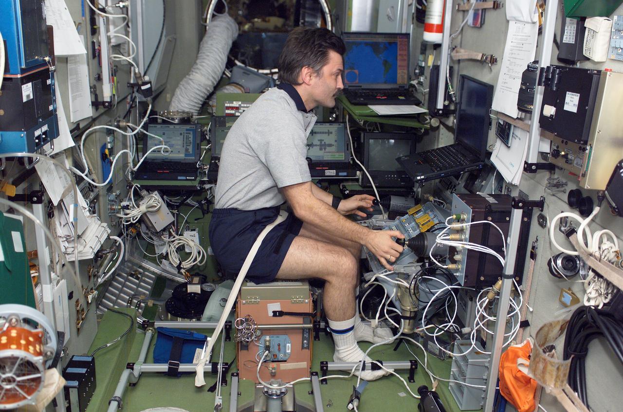ISS008-E-14067 (30 January 2004) --- Cosmonaut Alexander Y. Kaleri, Expedition 8 flight engineer, practices docking procedures with the manual TORU rendezvous system in the Zvezda Service Module on the International Space Station (ISS) in preparation for the docking of the Progress 13 on January 31. With the manual TORU mode, Kaleri can perform necessary guidance functions from Zvezda via two hand controllers in the event of a failure of the &#0147;Kurs&#0148; automated rendezvous and docking (AR&D) of the Progress. Kaleri represents Rosaviakosmos.