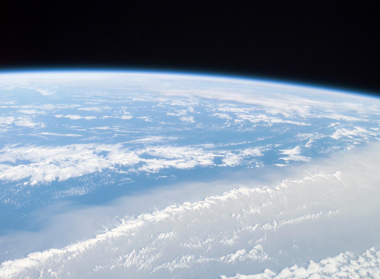 ISS008-E-18202 (8 March 2004) --- This image featuring a Saharan dust outbreak was taken by an Expedition 8 crewmember onboard the International Space Station (ISS) from a position about 1400 kilometers off the coast of Mauritania (about 600 kilometers west of the Cape Verde Islands in the tropical Atlantic Ocean). Looking northwest, this image shows the dusty Saharan air mass in the lower third of the view, with clear air beyond a marked northeast-trending boundary. The dust is blowing west-southwest, parallel to the front, a common trajectory during northern winters. The width of the dust column was about 1800 kilometers, of which 200 kilometers only are seen here (right).