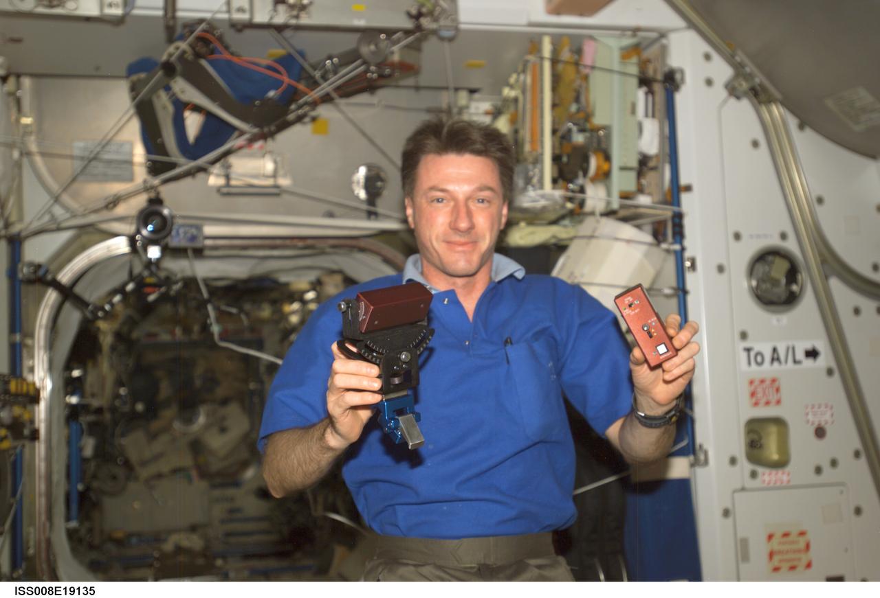 ISS008-E-19135 (24 March 2004) --- Astronaut C. Michael Foale, Expedition 8 commander and NASA ISS science officer, holds the Synchronized Position Hold, Engage, Reorient, Experimental Satellites (SPHERES) Beacon / Beacon Tester in the Unity node of the International Space Station.