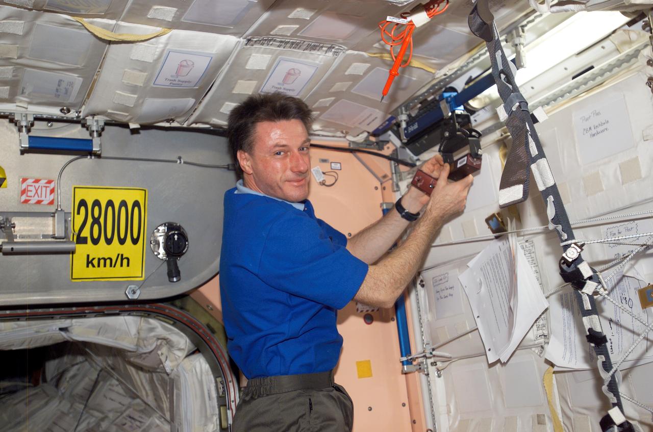 ISS008-E-19136 (24 March 2004) --- Astronaut C. Michael Foale, Expedition 8 commander and NASA ISS science officer, does a check of the Synchronized Position Hold, Engage, Reorient, Experimental Satellites (SPHERES) Beacon / Beacon Tester in the Unity node of the International Space Station.