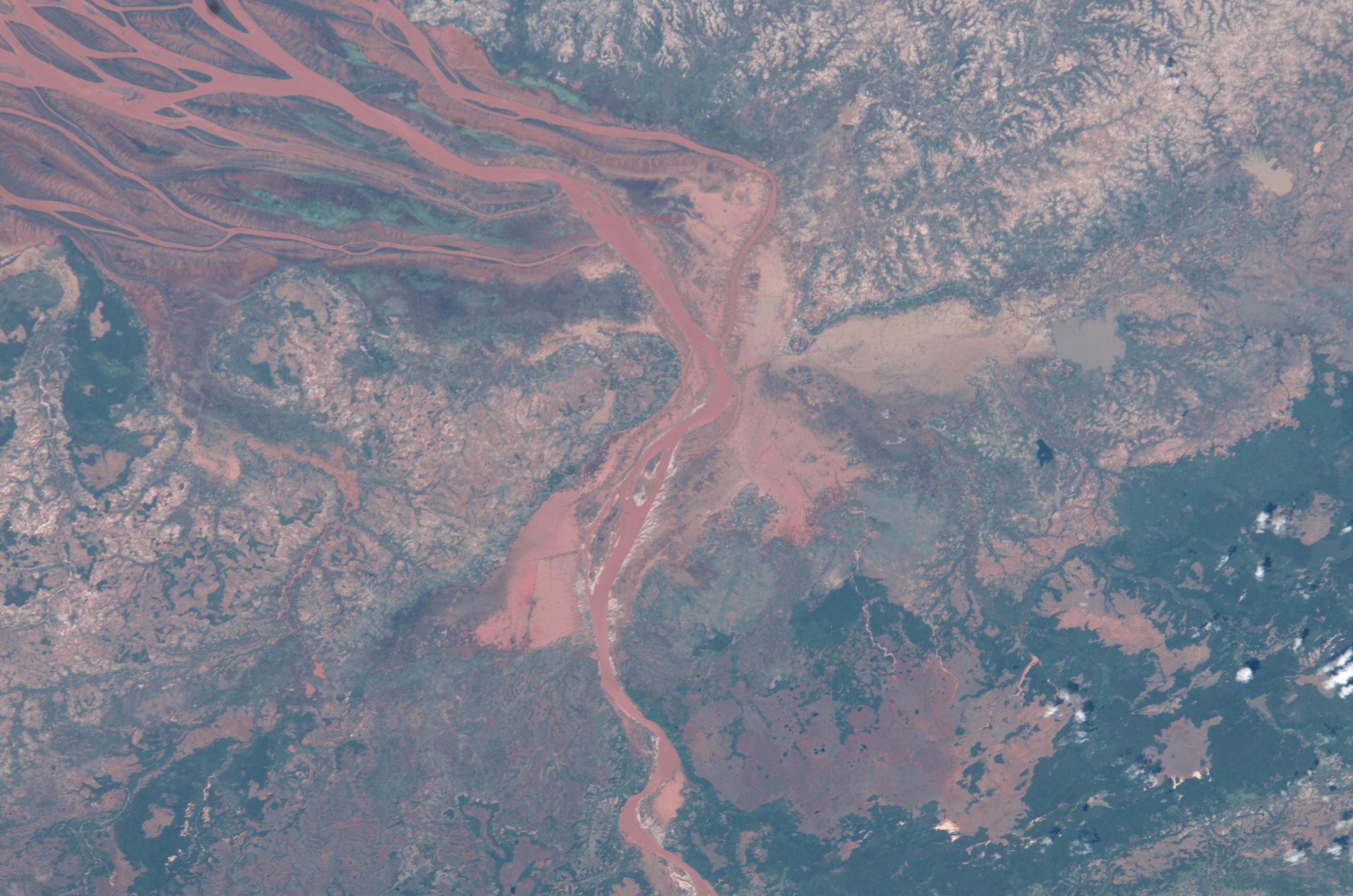 ISS008-E-19236 (25 March 2004) --- This image featuring the Betsiboka estuary on the northwest coast of Madagascar was taken by an Expedition 8 crewmember on the International Space Station (ISS). The Betsiboka estuary is the mouth of Madagascar’s largest river and one of the world’s fast-changing coastlines. Nearly a century of extensive logging of Madagascar’s rainforests and coastal mangroves has resulted in nearly complete clearing of the land and fantastic rates of erosion. After every heavy rain, the bright red soils are washed from the hillsides into the streams and rivers to the coast. Astronauts describe their view of Madagascar as “bleeding into the ocean”. One impact of the extensive 20th century erosion is the filling and clogging of coastal waterways with sediment – a process that is well illustrated in the Betsiboka estuary. In fact, ocean-going ships were once able to travel up the Betsiboka estuary, but must now berth at the coast.