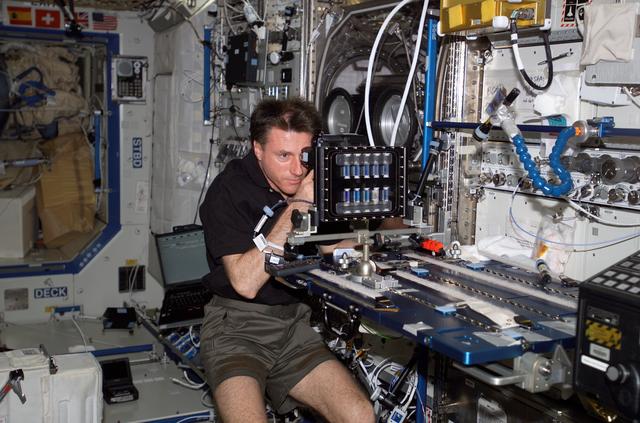 NASA image: Foale uses takes photographs of a BCAT SGSM in the  U.S. Lab during Expedition 8