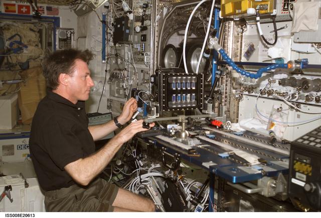 NASA image: Foale uses takes photographs of a BCAT SGSM in the  U.S. Lab during Expedition 8