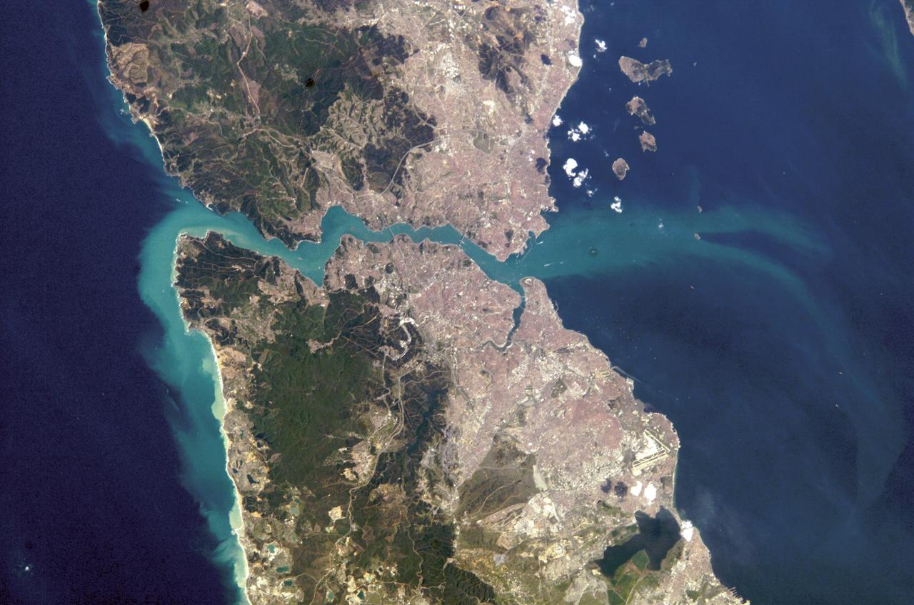 ISS008-E-21752 (16 April 2004) --- This image featuring Istanbul, Turkey was photographed by an Expedition 8 crewmember on the International Space Station (ISS). This metropolis of 15 million occupies both sides of the entrance to the narrow, 20-mile long Bosporus Strait connecting the Mediterranean and Sea of Marmara (south) to the Black Sea (north). When this image was taken, strong currents carried turbid coastal waters from the Black Sea through the Strait and into the Sea of Marmara. The rugged uplands to the north of the city are forested and contain vital reservoirs. Note Ataturk airport southwest of the city near the bottom of the image, the picturesque Prince Islands in the Sea of Marmara, and the sinuous waterway and harbor on the western shore known as the Golden Horn.
