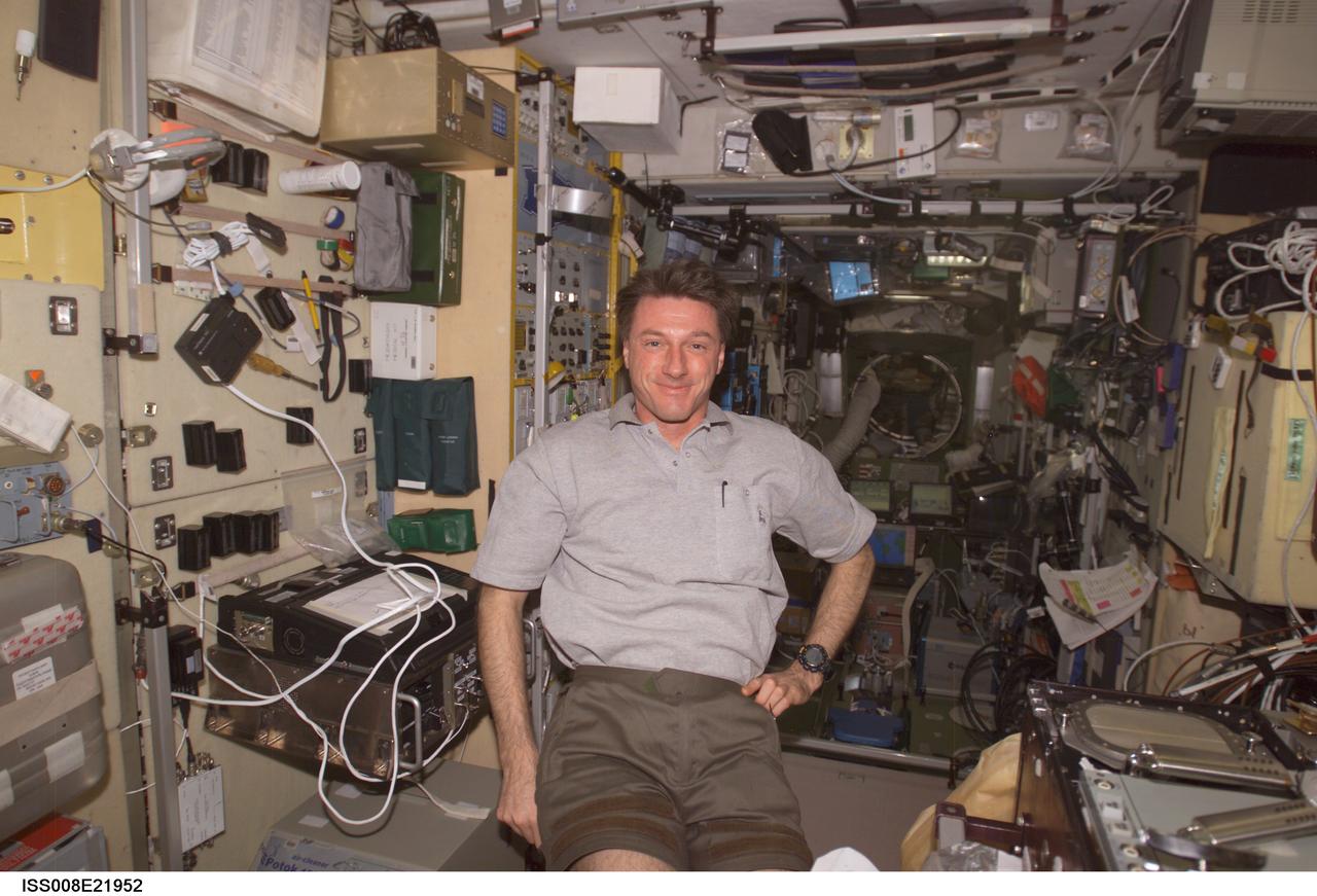 ISS008-E-21952 (21 April 2004) --- A smiling astronaut C. Michael Foale, Expedition 8 commander and NASA ISS science officer, can't hide his elation at having company aboard the International Space Station in this electronic still photo, taken in the Zvezda Service Module soon after three visitors arrived at the orbiting complex in a Russian Soyuz spacecraft.