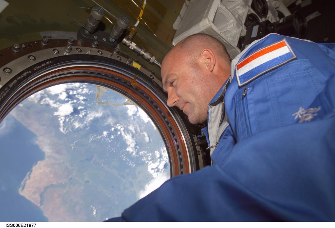 ISS008-E-21977 (21 April 2004) --- European Space Agency (ESA) astronaut Andre Kuipers of the Netherlands looks through the Earth observation window in the Destiny laboratory on the International Space Station soon after arriving in a Soyuz spacecraft for several days' stay onboard the Earth-orbiting complex.