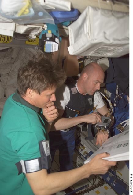 NASA image: Padalka and Kuipers review a procedures book in Node 1 during EXP 9 / EXP 8