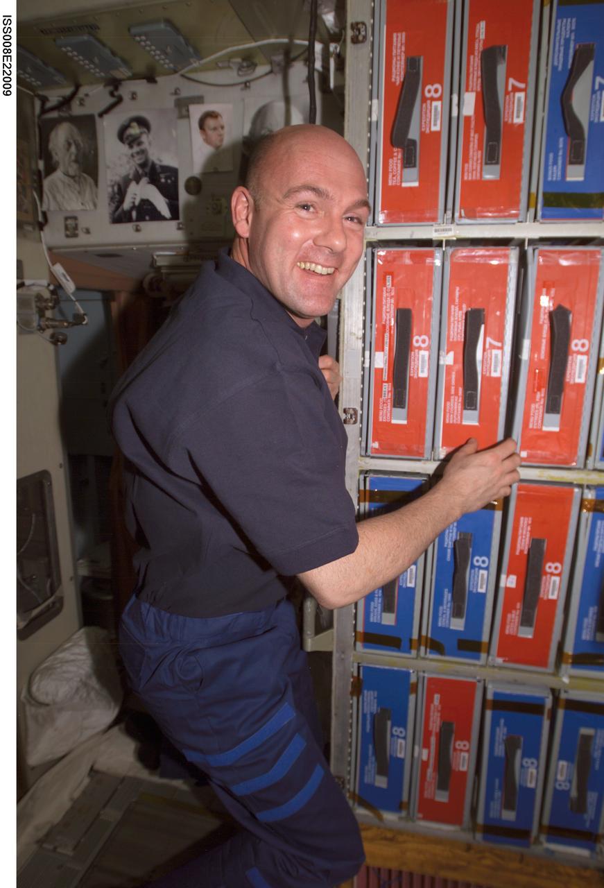 ISS008-E-22009 (22 April 2004) --- European Space Agency (ESA) astronaut Andre Kuipers of the Netherlands is pictured near food storage containers in the Zvezda Service Module of the International Space Station (ISS).