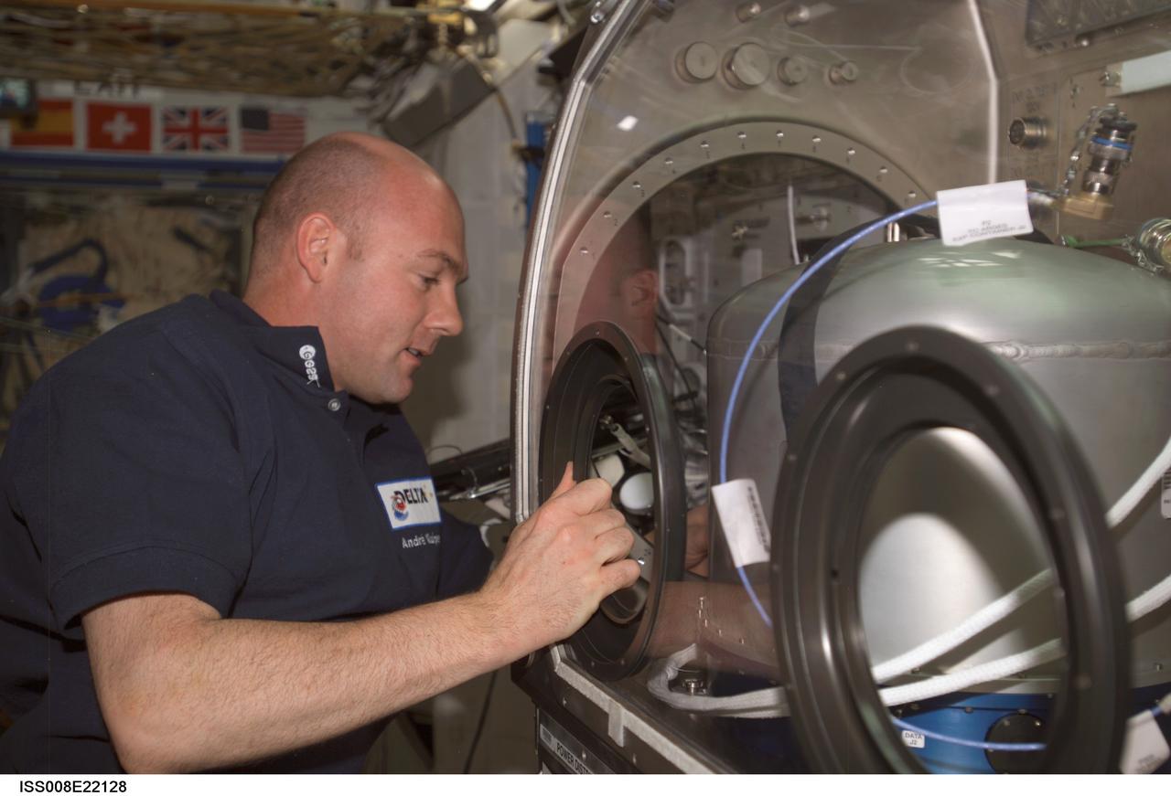 ISS008-E-22128 (24 April 2004) --- European Space Agency (ESA) astronaut Andre Kuipers of the Netherlands works with the ARGES experiment for the Microgravity Science Glovebox (MSG) in the Destiny laboratory of the International Space Station (ISS). The main objectives of ARGES are to determine which factors are critical in the onset of instabilities in High-Intensity Discharge (HID) lamps and to characterize the separation of individual gaseous elements inside.