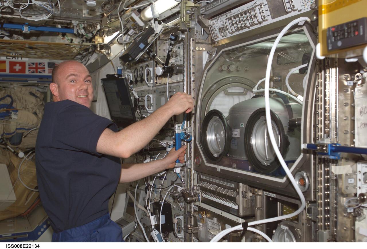 ISS008-E-22134 (24 April 2004) --- European Space Agency (ESA) astronaut Andre Kuipers of the Netherlands is pictured near the Microgravity Science Glovebox (MSG) in the Destiny laboratory of the International Space Station (ISS).