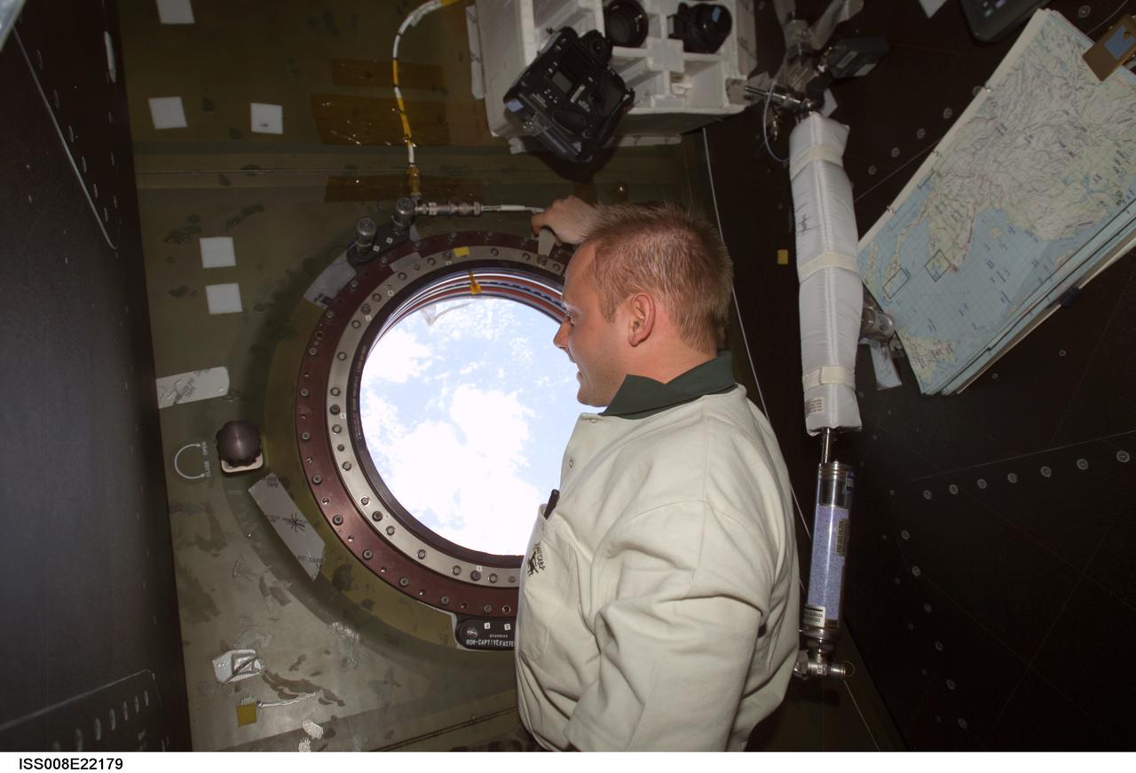 ISS008-E-22179 (25 April 2004) --- Astronaut Edward M. (Mike) Fincke, Expedition 9 NASA ISS science officer and flight engineer, views the topography of a point on Earth from the nadir window in the Destiny laboratory of the International Space Station (ISS).