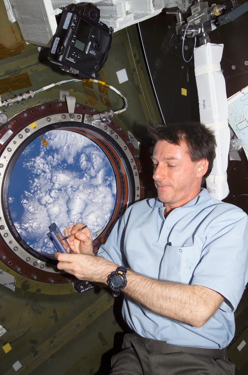 ISS008-E-22183 (25 April 2004) --- Astronaut C. Michael Foale, Expedition 8 commander and NASA ISS science officer, holds a Personal Digital Assistant (PDA) near the nadir window in the Destiny laboratory of the International Space Station (ISS).