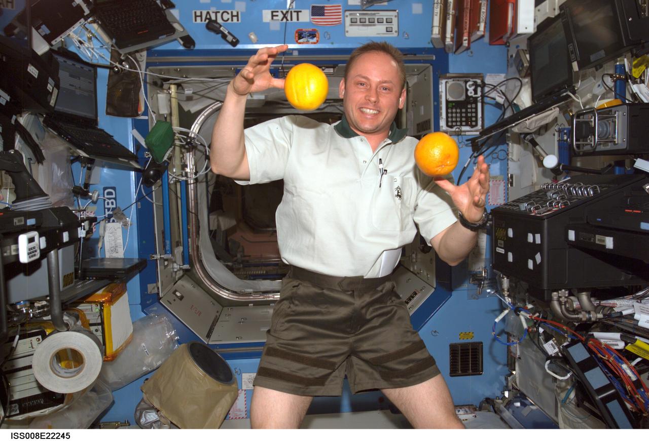 ISS008-E-22245 (22 April 2004) --- Astronaut Edward M. (Mike) Fincke, Expedition 9 NASA ISS science officer and flight engineer, “juggles” fresh fruit in the Destiny laboratory of the International Space Station (ISS). The weightless environment of space proves to be an ideal location for some tasks not so easily accomplished in Earth’s gravity.