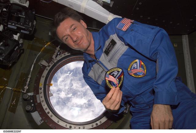 Foale, holding EXP 8 patch, poses beside science window in the U.S. Lab