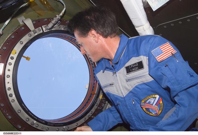 NASA image: Foale peers through the science window in the U.S. Lab during Expedition 8