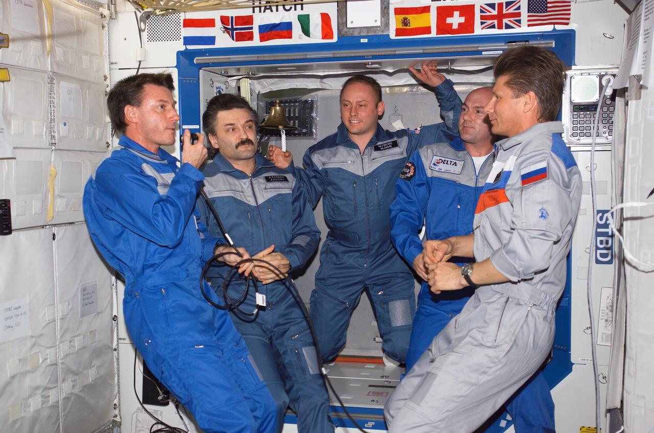 ISS008-E-22320 (26 April 2004) --- The crewmembers onboard the International Space Station (ISS) gather in the Destiny laboratory for the ceremony of Changing-of Command from Expedition 8 to Expedition 9. From the left are astronaut C. Michael Foale, Expedition 8 commander and NASA ISS science officer; cosmonaut Alexander Y. Kaleri, Expedition 8 flight engineer; astronaut Edward M. (Mike) Fincke, Expedition 9 NASA ISS science officer and flight engineer; European Space Agency (ESA) astronaut Andre Kuipers of the Netherlands; and cosmonaut Gennady I. Padalka, Expedition 9 commander. Kaleri and Padalka represent Russia&#0146;s Federal Space Agency.
