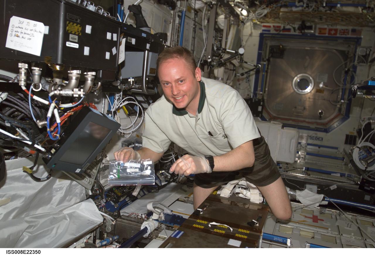 ISS008-E-22350 (27 April 2004) --- Astronaut Edward M. (Mike) Fincke, Expedition 9 NASA ISS science officer and flight engineer, works in the Destiny laboratory of the International Space Station (ISS).