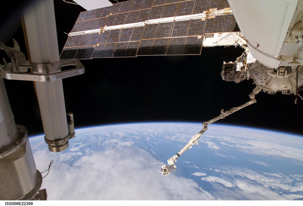 ISS008-E-22399 (28 February 2004) --- This view, taken during Expedition 8 extravehicular activity (EVA), shows the Strela Cargo Boom at left; and the functional cargo block (FGB) or Zarya; Pressurized Mating Adapter (PMA-3); Destiny laboratory and Canadarm2, or Space Station Remote Manipulator System (SSRMS), at right, backdropped against Earth&#0146;s horizon and the blackness of space.