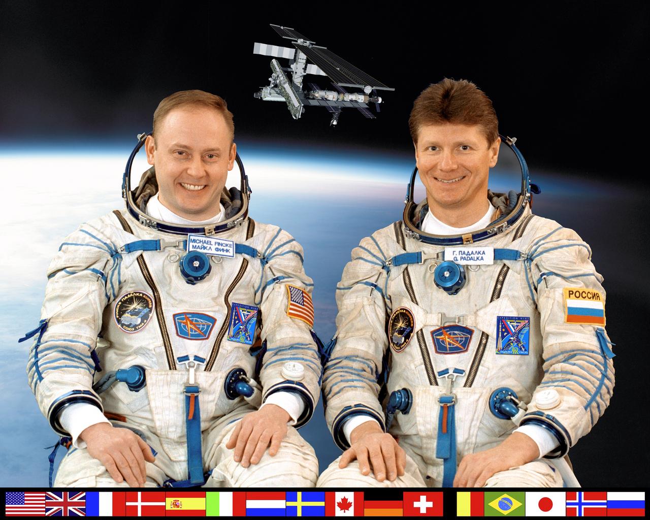 ISS009-S-002 (March 2004) --- Astronaut Edward M. (Mike) Fincke (left), Expedition Nine NASA ISS science officer and flight engineer, and cosmonaut Gennady I. Padalka, commander, pose for their crew portrait while in training at the Gagarin Cosmonaut Training Center in Star City, Russia for their scheduled launch in the spring of this year in a Soyuz TMA-4 spacecraft. Padalka represents the Russian Federal Space Agency.