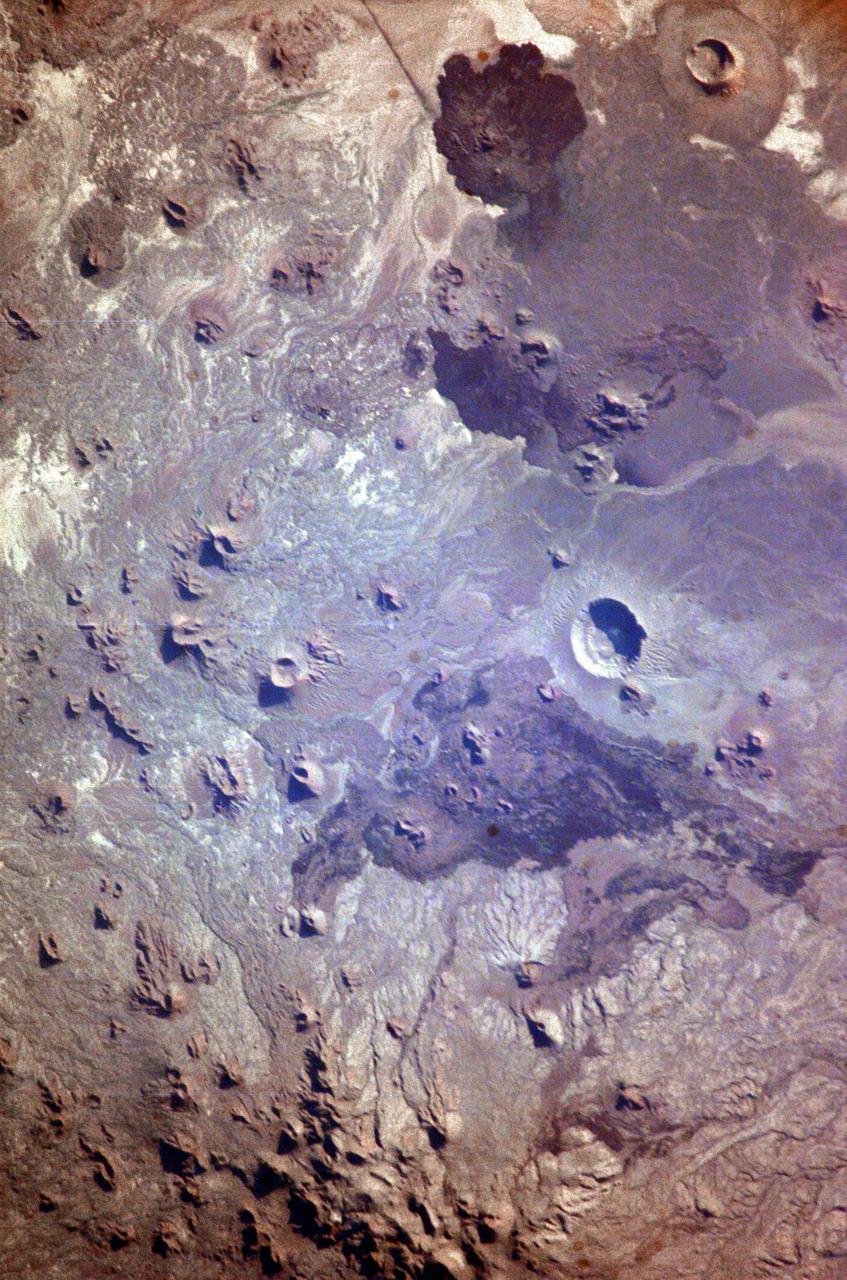 ISS009-E-05944 (7 May 2004) --- The Pinacates Biosphere Reserve is featured in this image photographed by an Expedition 9 crewmember on the International Space Station (ISS). The Pinacates—a moon-like volcanic landscape that lies in the Sonoran Desert in Mexico just a few miles from the border with Arizona—is one of the most unique and striking landscapes in North America. The volcanic range is surrounded by one of North America’s largest dune fields, Gran Desierto. The natural history of the region includes thousands of years of human occupation; it is the aboriginal homeland of the O’Odham tribe, also known as the Papago. The region also served as an early training site for Apollo astronauts in the mid-late 1960s. The name Pinacate is derived from “pinacatl,” the Aztec name for the desert stink beetle which is common in the region. The natural and cultural resource management of the region, including the archeological sites and the high biodiversity, is now guaranteed: the site was declared a UNESCO Biosphere Reserve in 1993. The high-resolution image provides a view of a large volcanic crater called Crater Elegante, which is one of the most prominent and interesting features of the Pinacates.