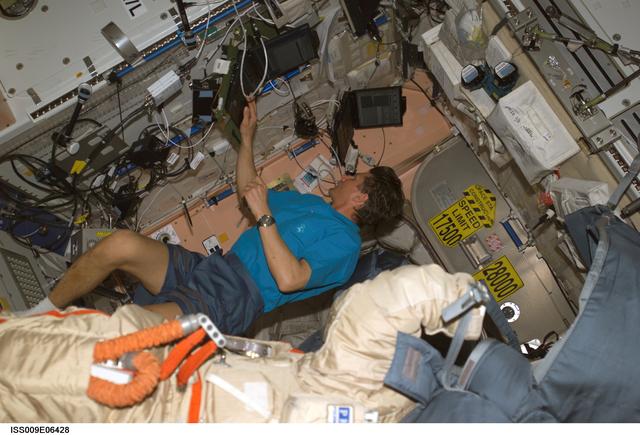 NASA image: Padalka prepares to checkout an Orlan suit during Expedition 9