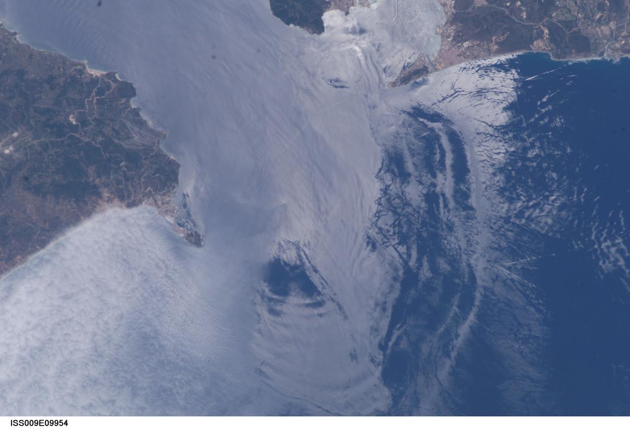 ISS009-E-09954 (3 June 2004) --- Large internal waves in the Strait of Gibraltar are featured in this scene photographed by an Expedition 9 crewmember on the International Space Station (ISS). These subsurface internal waves occur at depths of about 100 meters, but appear in the sun glint as giant swells flowing eastward into the Mediterranean Sea. This image was merged with image ISS009-E-09952 to create a mosaic, which can be viewed on http://eol.jsc.nasa.gov.