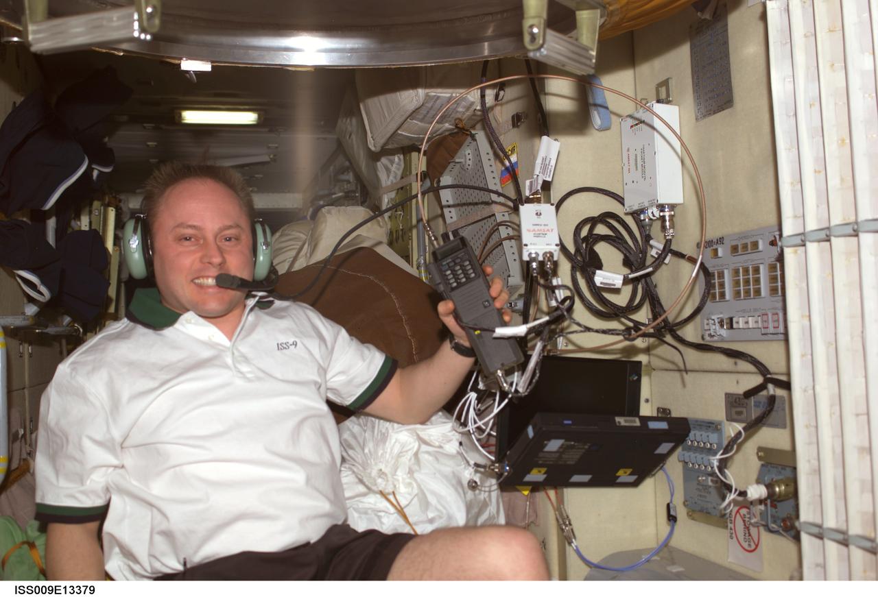ISS009-E-13379 (28 June 2004) --- Astronaut Edward M. (Mike) Fincke, Expedition 9 NASA ISS science officer and flight engineer, uses a communication system in the Zvezda Service Module of the International Space Station (ISS).
