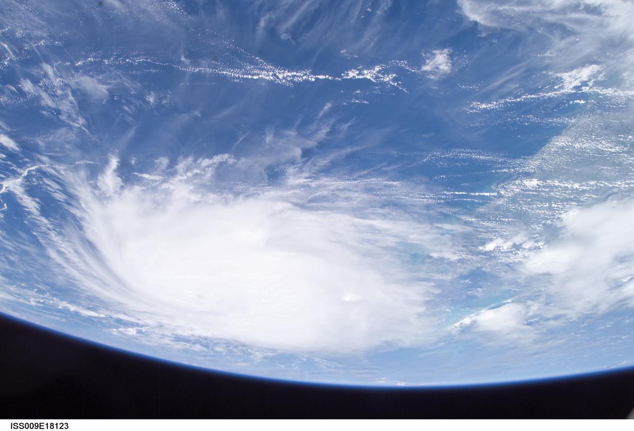 ISS009-E-18123 (21:08:33 GMT, 12 August 2004) --- This panoramic view of Hurricane Charley was taken by the Expedition 9 crew of the International Space Station just after 5PM (EDT), August 12, 2004. The Category Two Hurricane was in the northwest Caribbean Sea, 140 miles south-southeast of Havana, Cuba moving north-northwest at 18mph packing winds of 105mph. In this view looking southeast, the newly formed eye of the storm is just visible and the west coast of Florida from Naples to Tampa Bay may be seen on the right.