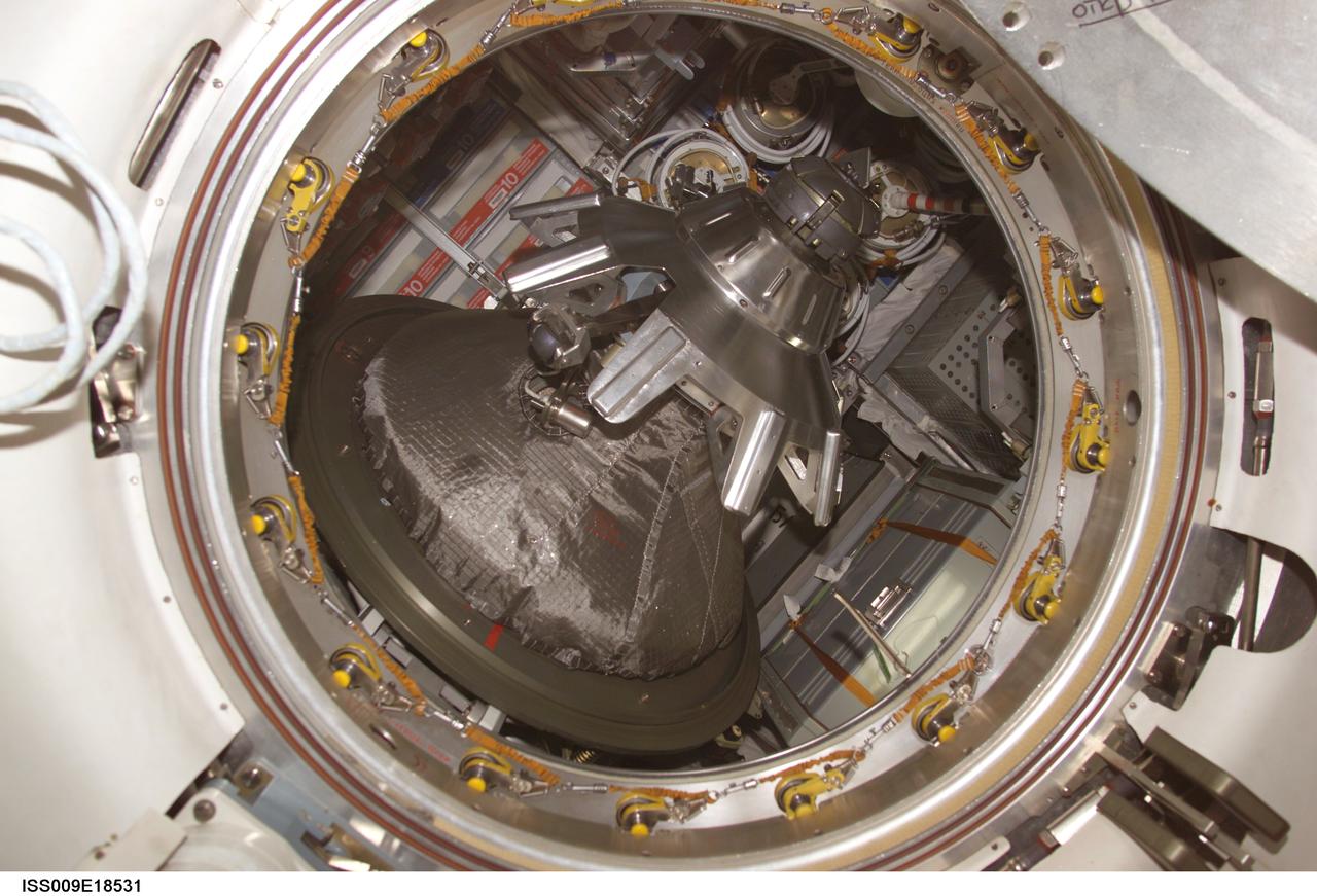ISS009-E-18531 (14 August 2004) --- Looking into the Progress 15 supply vehicle docked to aft port on the Zvezda Service Module of the International Space Station (ISS), this view shows the probe-and-cone mechanism on the hatch.