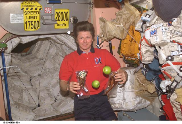 NASA image: Padalka holds packages of food unloaded from the Progress 15P vehicle during Expedition 9