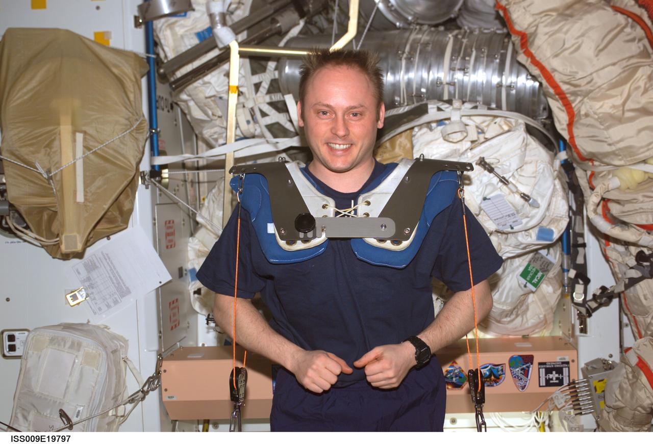 ISS009-E-19797 (23 August 2004) --- Astronaut Edward M. (Mike) Fincke, Expedition 9 NASA ISS science officer and flight engineer, wearing squat harness pads, exercises using the Interim Resistive Exercise Device (IRED) equipment in the Unity node on the International Space Station (ISS).