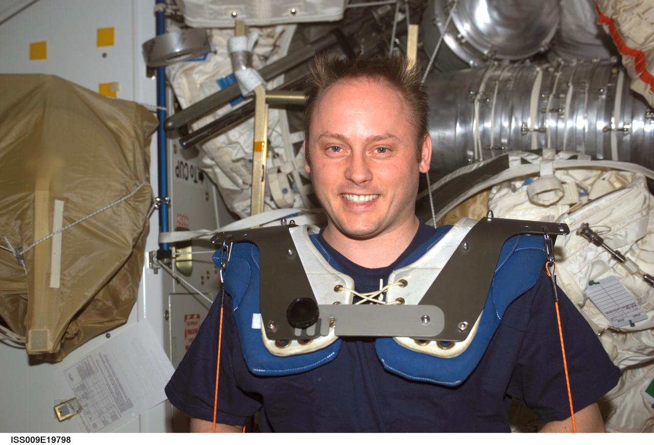 ISS009-E-19798 (23 August 2004) --- Astronaut Edward M. (Mike) Fincke, Expedition 9 NASA ISS science officer and flight engineer, wearing squat harness pads, exercises using the Interim Resistive Exercise Devise (IRED) equipment in the Unity node of the International Space Station (ISS).