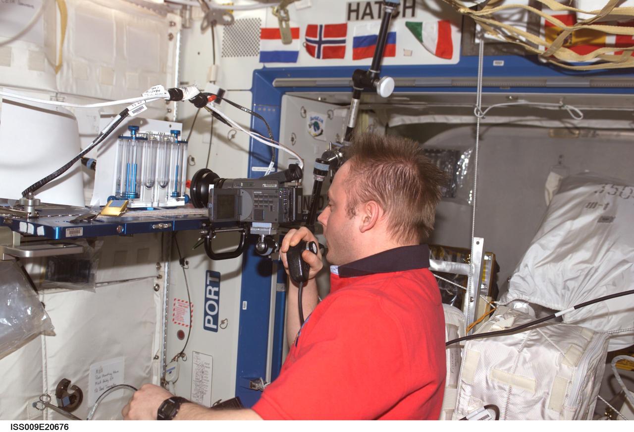 ISS009-E-20676 (28 August 2004) --- Astronaut Edward M. (Mike) Fincke, Expedition 9 NASA ISS science officer and flight engineer, performs one of multiple tests of the Capillary Flow Experiment (CFE) investigation in the Destiny laboratory of the International Space Station (ISS). CFE observes the flow of fluid, in particular capillary phenomena, in micro-G.