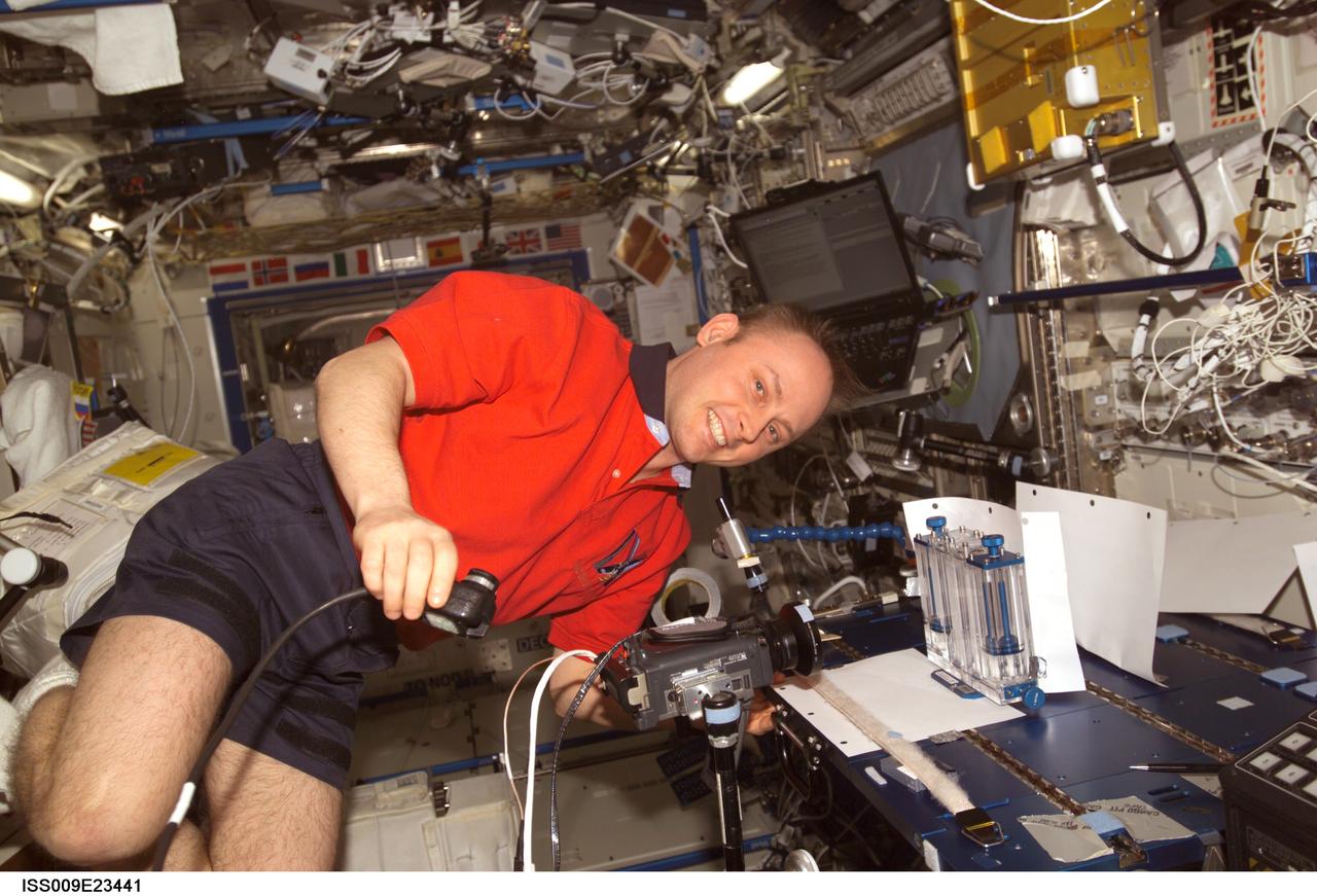 ISS009-E-23441 (18 September 2004) --- Astronaut Edward M. (Mike) Fincke, Expedition 9 NASA ISS science officer and flight engineer, performs one of multiple tests of the Capillary Flow Experiment (CFE) investigation in the Destiny laboratory of the International Space Station (ISS). CFE observes the flow of fluid, in particular capillary phenomena, in micro-G.