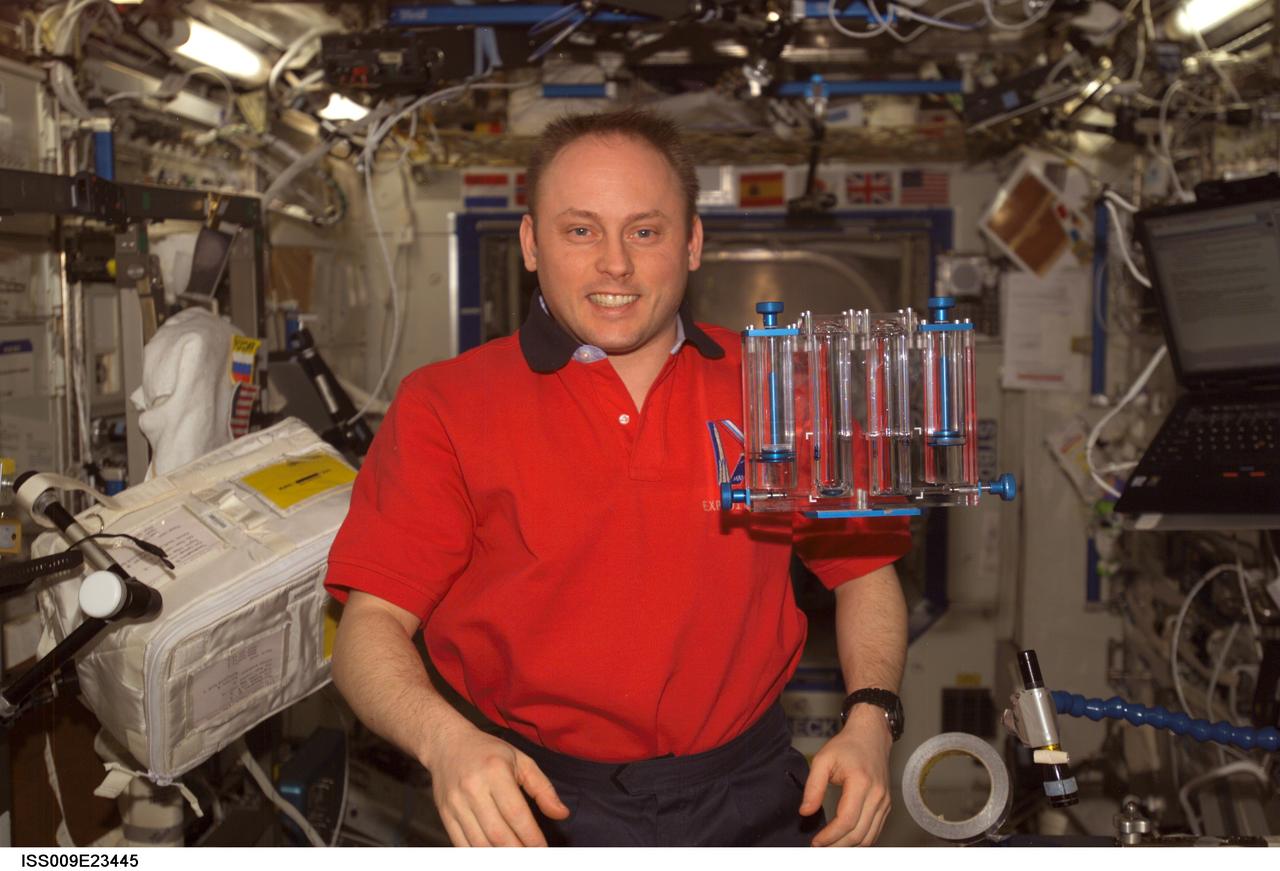 ISS009-E-23445 (18 September 2004) --- Astronaut Edward M. (Mike) Fincke, Expedition 9 NASA ISS science officer and flight engineer, is pictured in the Destiny laboratory of the International Space Station (ISS). The Capillary Flow Experiment (CFE), which observes the flow of fluid, in particular capillary phenomena, in micro-G, floats freely in the foreground.