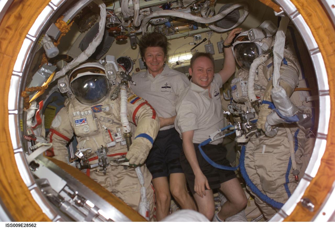 ISS009-E-28562 (2 August 2004) --- Cosmonaut Gennady I. Padalka (left), Expedition 9 commander representing Russia’s Federal Space Agency, and astronaut Edward M. (Mike) Fincke, NASA ISS science officer and flight engineer, pose with their Russian Orlan spacesuits in the Pirs Docking Compartment of the International Space Station (ISS).