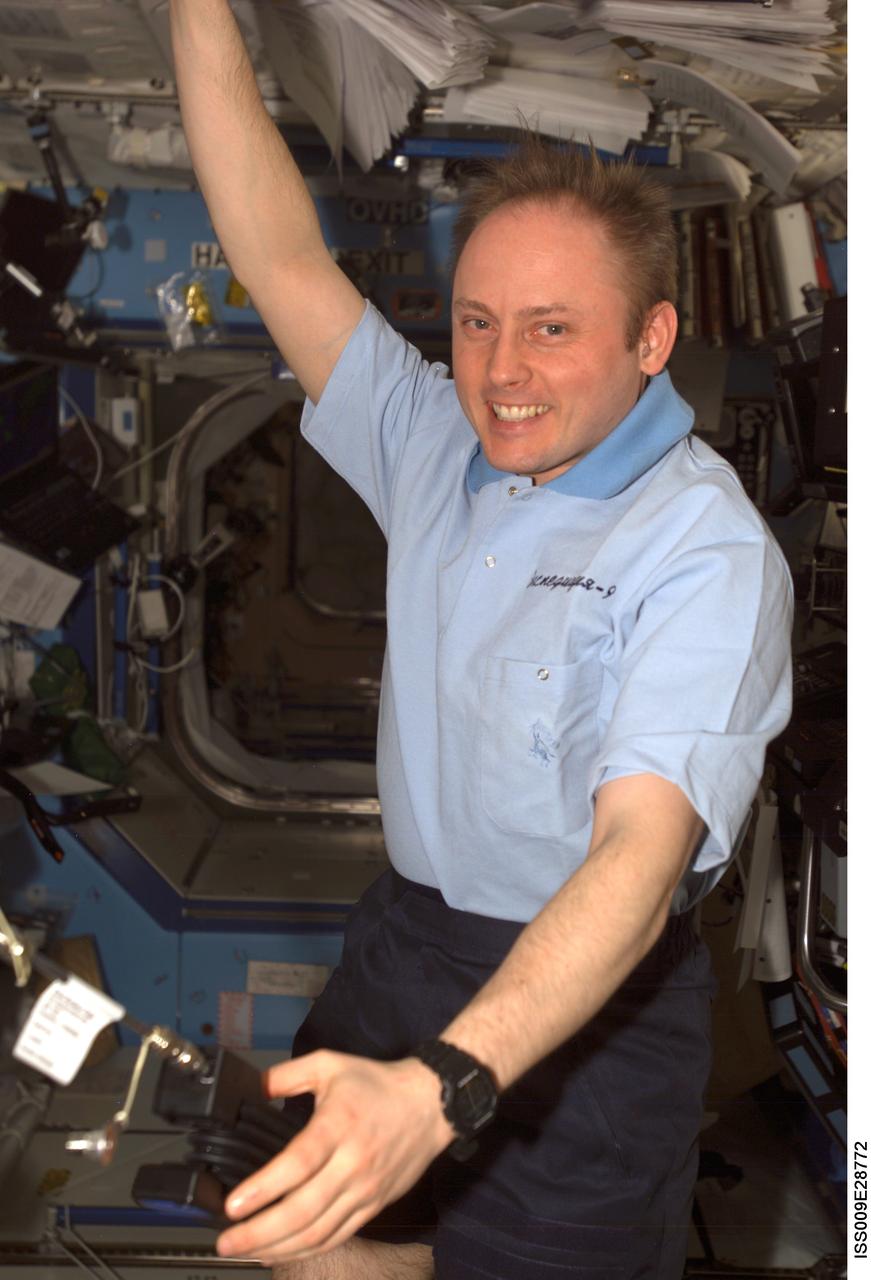 ISS009-E-28772 (14 October 2004) --- Astronaut Edward M. (Mike) Fincke, Expedition 9 NASA ISS science officer and flight engineer, uses a Dual Sorbent Tube and its associated pump to take routine air samples in the Destiny laboratory of the International Space Station (ISS).