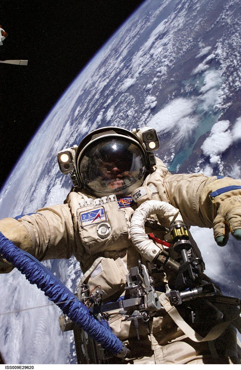 ISS009-E-29620 (3 August 2004) --- Astronaut Edward M. (Mike) Fincke, Expedition 9 NASA ISS science officer and flight engineer, wearing a Russian Orlan spacesuit, participates in the third of four sessions of extravehicular activities (EVA) performed by the Expedition 9 crew during their six-month mission. Fincke and cosmonaut Gennady I. Padalka (out of frame), commander representing Russia's Federal Space Agency, spent 4 ½ hours outside the Station swapping out experiments and installing hardware associated with Europe’s Automated Transfer Vehicle (ATV), scheduled to launch on its maiden voyage to ISS next year. A cloudy Earth provided the backdrop for the image.